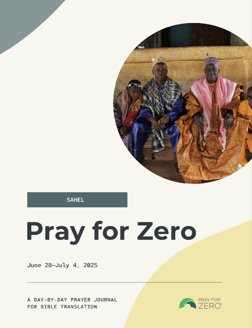 Three men and a young boy in traditional clothing sit outside a building in the Sahel region, representing communities without Scripture in their language.